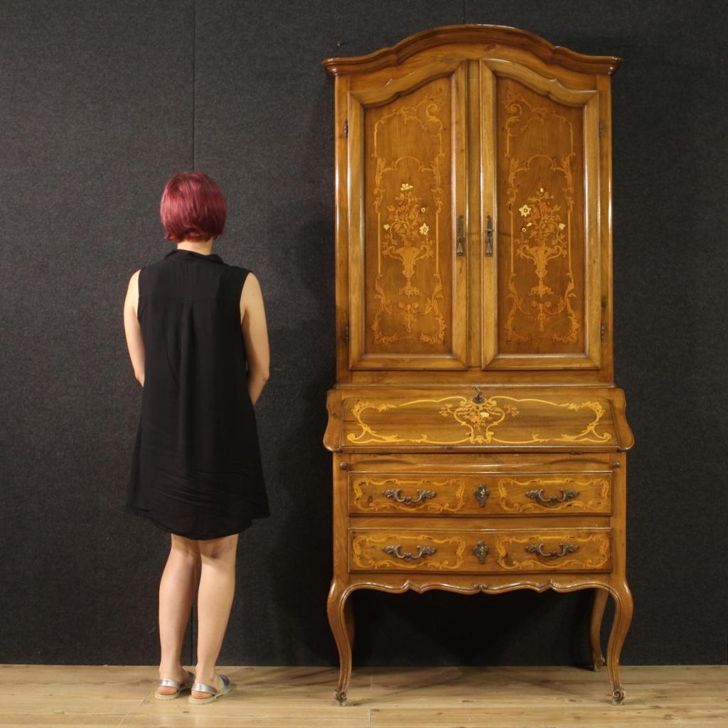 Italian trumeau from 20th century. Louis XV style furniture nicely inlaid in walnut, maple and fruitwood. Double body trumeau equipped with two drawers and fall-front in the lower part. Inside of the bureau with two drawers, four compartments for