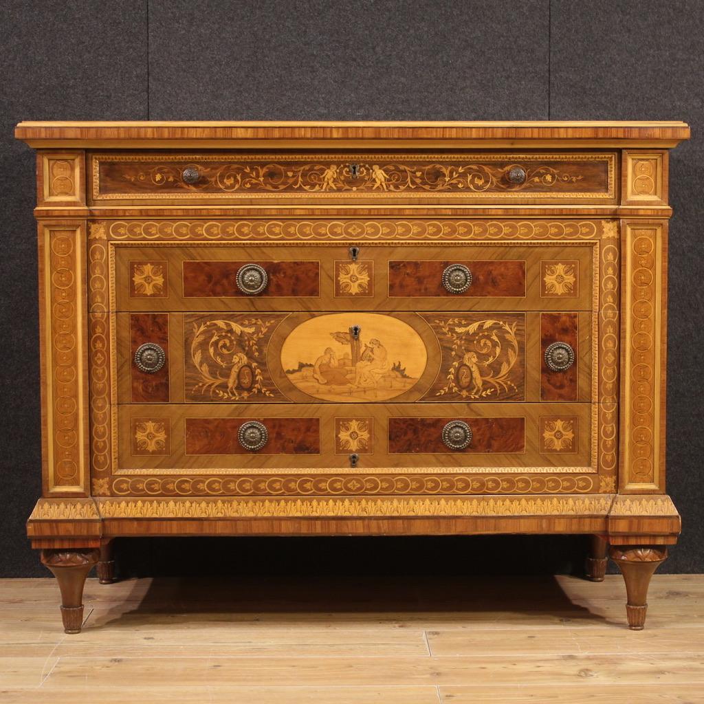 20th century Italian Louis XVI style chest of drawers. Chest of drawers richly inlaid with floral and geometric motifs and a landscape with musicians in fruit wood, palisander, ebonized wood, rosewood, burl and mahogany. Imposing and scenic
