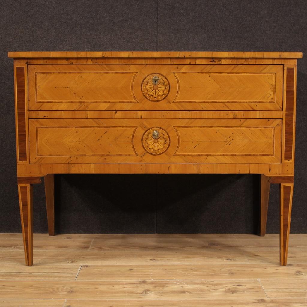 Italian dresser from the mid-20th century. Louis XVI style furniture pleasantly inlaid in walnut, cherry, maple and fruitwood. Chest of drawers adorned with rosettes placed on the top, on the sides and in the center of the two drawers (see photo).