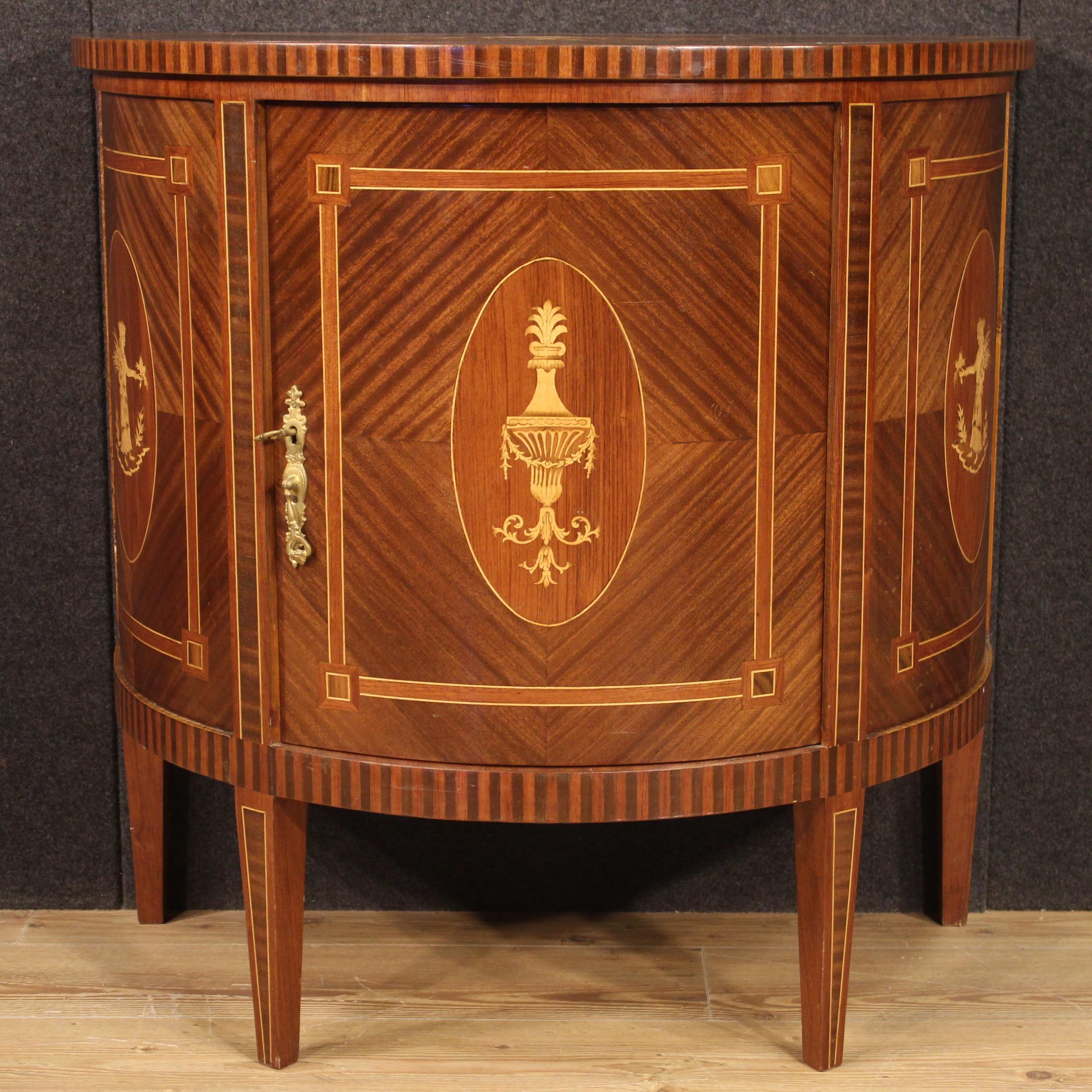 Italian demilune sideboard from 20th century. Inlaid furniture in mahogany, walnut, maple, rosewood and fruitwood in Louis XVI style. Sideboard with one door complete with working key equipped with an internal shelf. Furniture supported by four feet