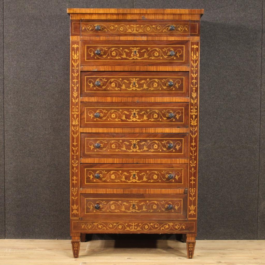 Italian tallboy from the mid-20th century. Louis XVI style chest of drawers richly inlaid in walnut, mahogany, maple, cherry and fruitwood. Chest of drawers with seven drawers (see photo) of which the central one complete with fall-front top, four