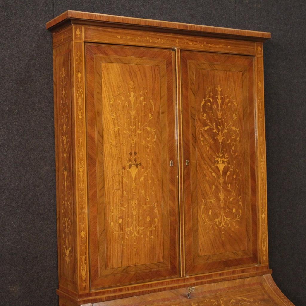 Italian trumeau from the mid-20th century. Louis XVI style furniture richly inlaid with floral decorations in walnut, rosewood, maple, boxwood and fruitwood. Double body trumeau equipped with two drawers and fall-front at the bottom. Interior with