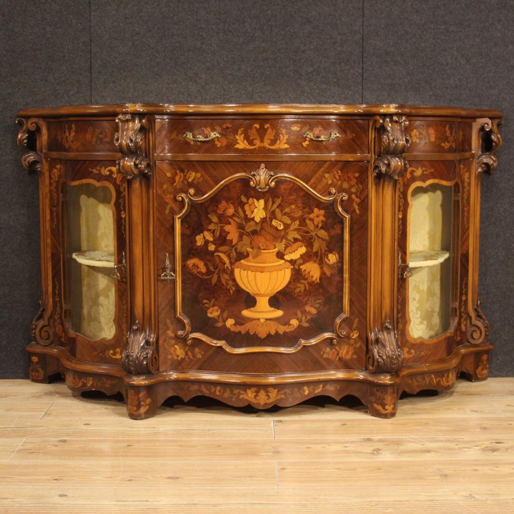 Italian sideboard from the second half of the 20th century. Furniture richly carved and inlaid with floral decorations in walnut, maple, burl, cherry, beech and fruitwood (see photo). Sideboard with three doors and a central drawer, of excellent
