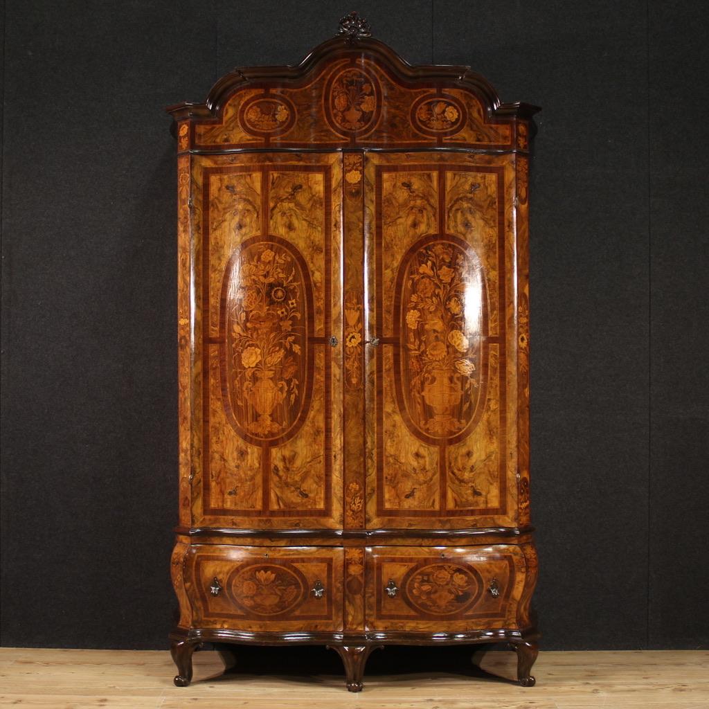 Lombard wardrobe from the mid-20th century. Louis XV style furniture finely inlaid with floral decorations in walnut, burl, rosewood, maple, ebonized wood and fruitwood, of excellent quality. Wavy and curved wardrobe, ideal for a bedroom or large