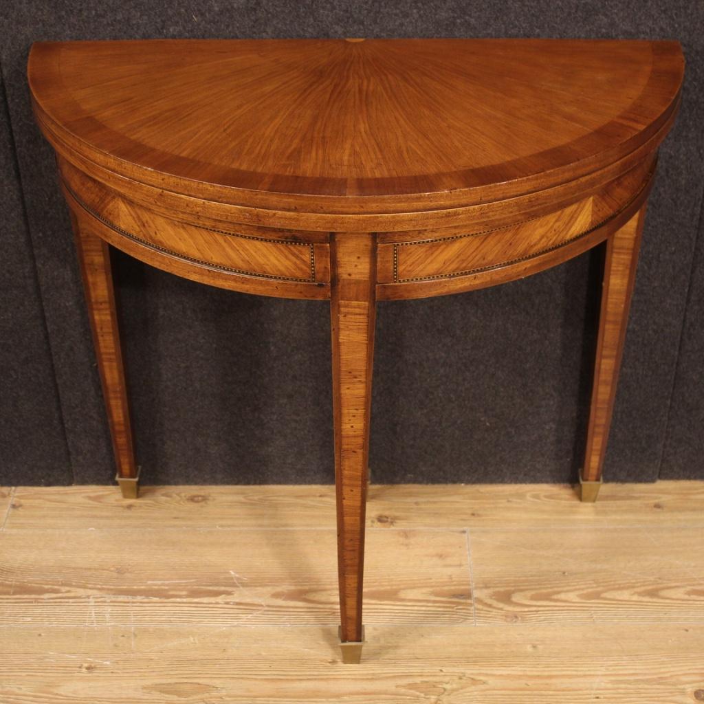 French side table from 20th century. Louis XVI style inlaid furniture in mahogany, maple, ebonized wood and fruit wood. Opening demilune table that offers, once opened, a round inlaid top of 80 cm in diameter (see photo). Furniture of excellent