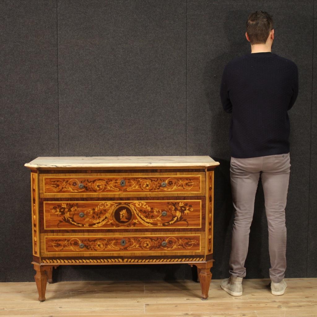 Italian chest of drawers from the 20th century. Furniture richly inlaid with floral decorations in Louis XVI style in walnut, maple, rosewood, bois de rose, beech and fruitwood. Chest of drawers with marble top with pink shades (see picture) and