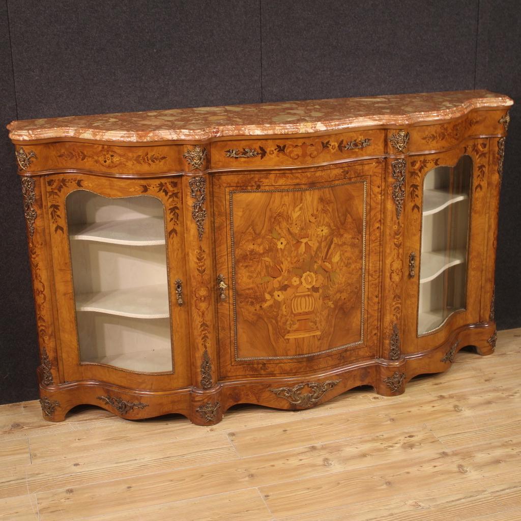 French sideboard from the second half of the 20th century. Moved and rounded piece of furniture, richly inlaid and adorned with gilded and chiseled bronze and brass, in Napoleon III style. Servant of great size and impact inlaid and veneered in