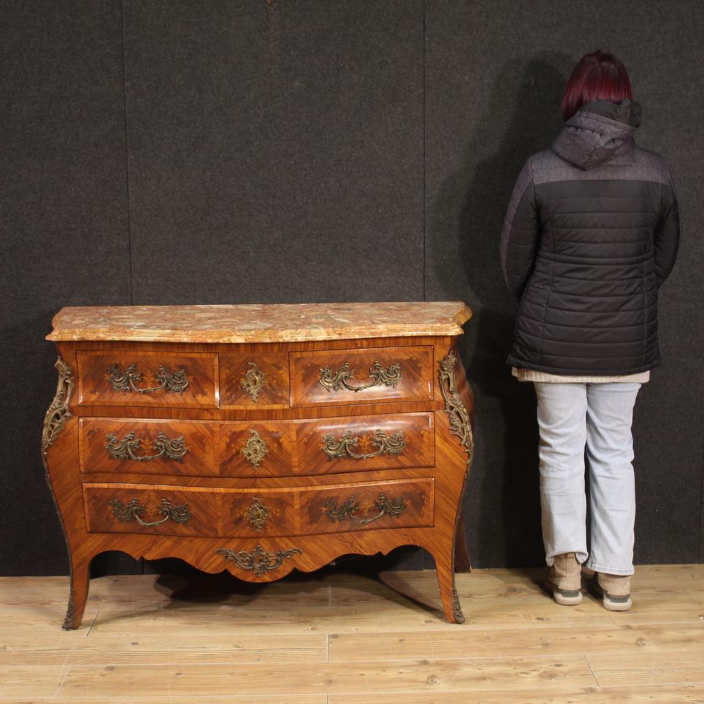 French chest of drawers from the mid 20th century. Wavy and rounded furniture, in Louis XV style, finely adorned with floral inlay in rosewood and fruitwood. Nicely sized dresser of pleasant furnishings complete with original marble of good size and