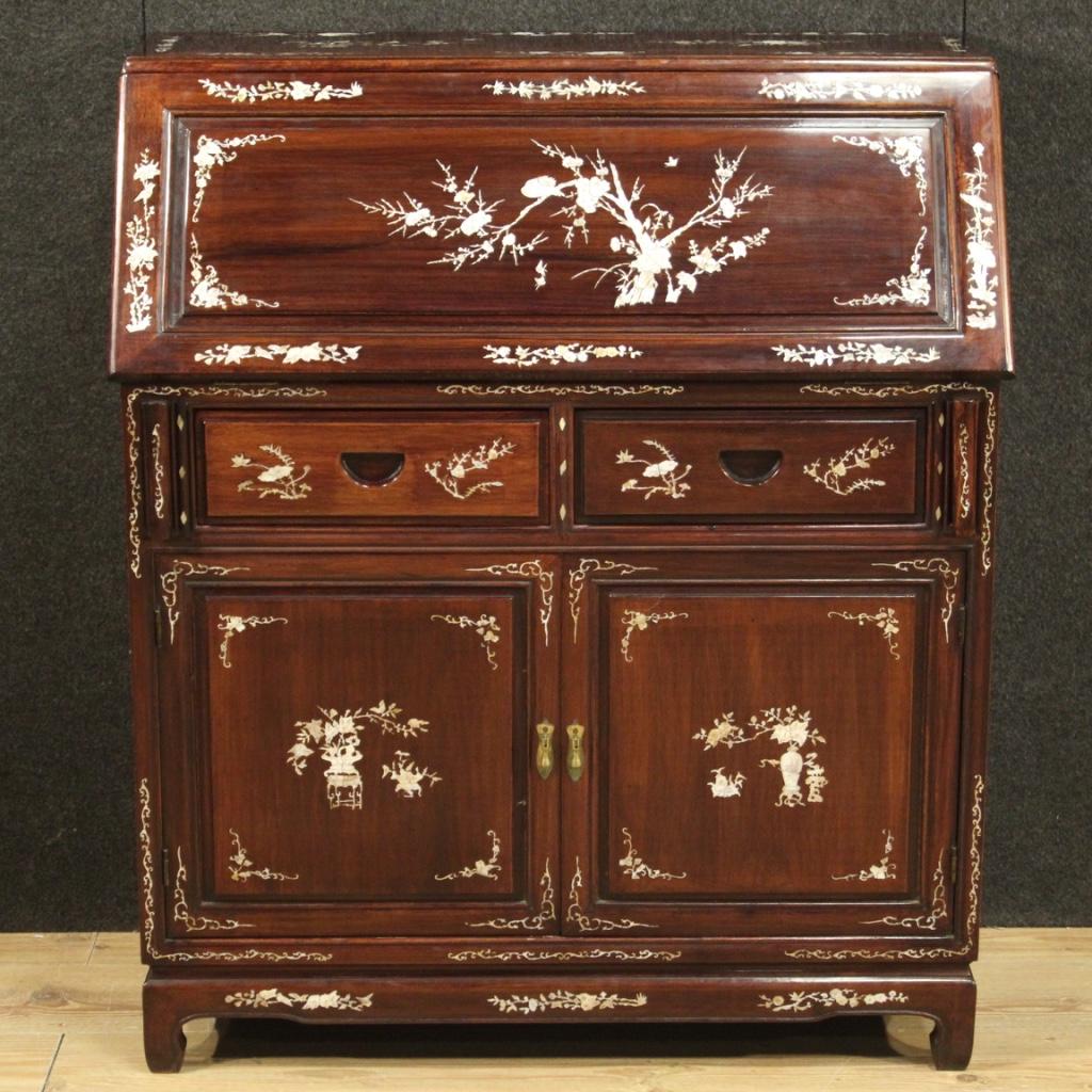 Oriental bureau of the second half of the 20th century. Furniture of exceptional quality carved in mahogany and exotic woods adorned with rich inlay in faux mother of pearl with floral decorations. Large capacity bureau equipped with two doors, two