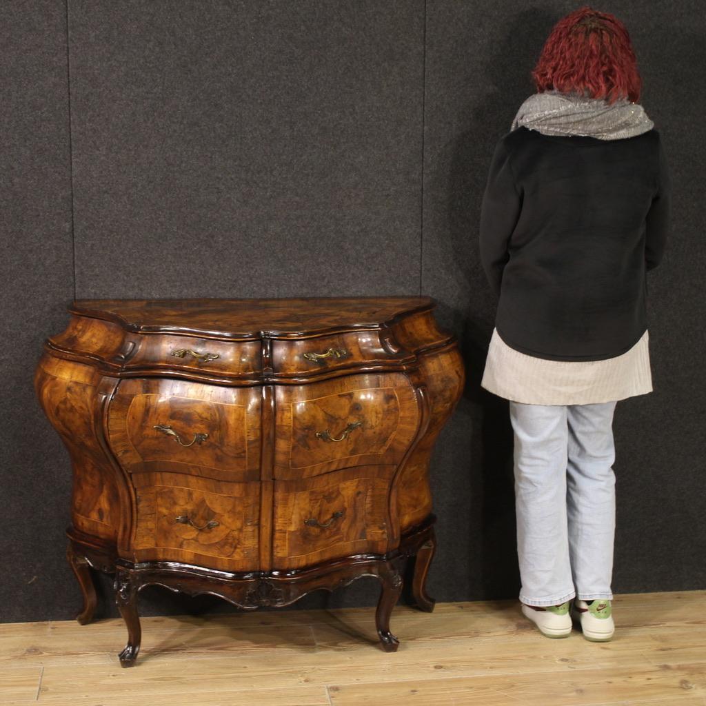 Venetian chest of drawers from the first half of the 20th century. Moved and rounded furniture of fabulous line and pleasant decor sculpted, veneered and inlaid in walnut, burl, maple and beech woods. Commode equipped with two large drawers in the