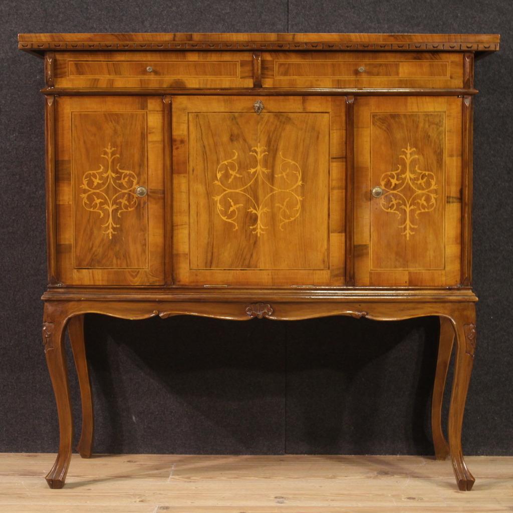 Elegant Italian sideboard from the 20th century. Venetian style furniture inlaid in walnut, maple and fruitwood. Sideboard with two side doors with internal shelves and central fall front door, of excellent service. Cabinet equipped with two drawers