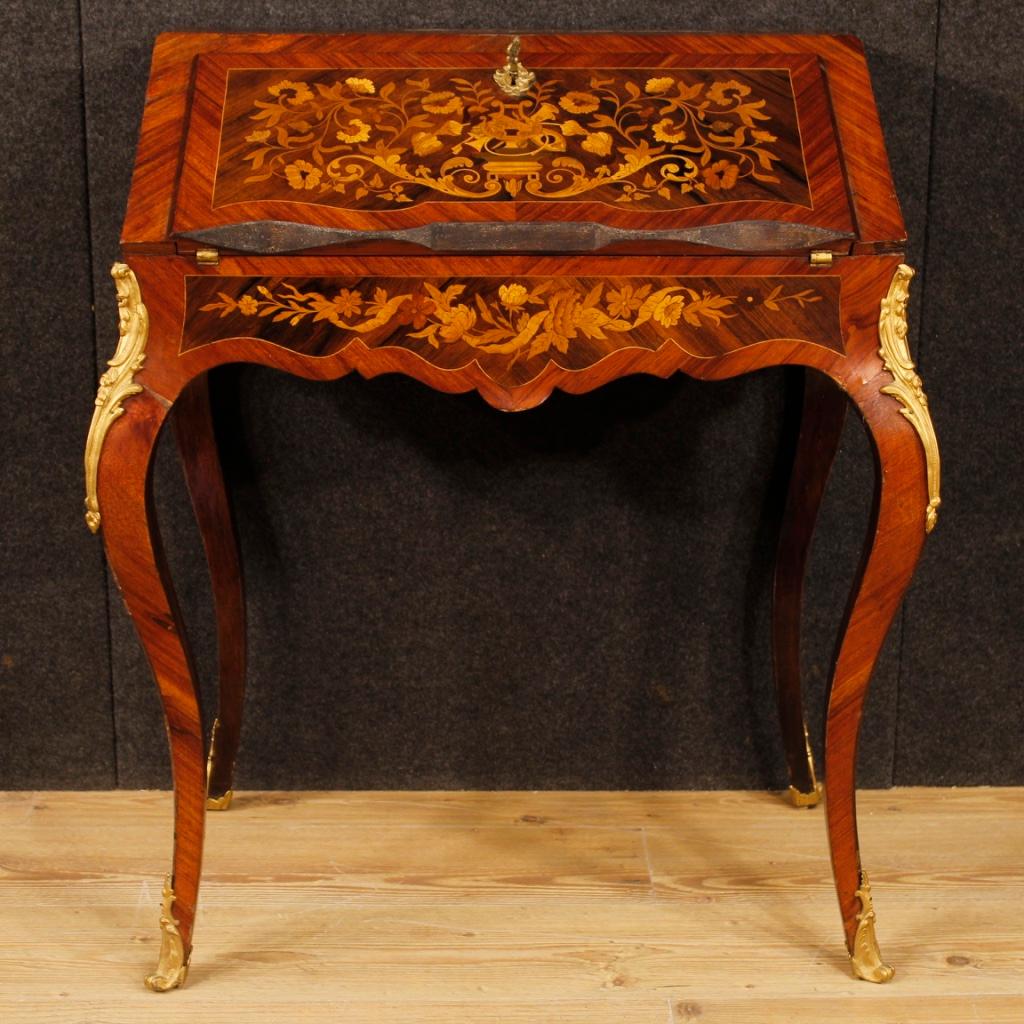 French bureau from the first half of the 20th century. Furniture richly inlaid in mahogany, palisander, maple, walnut, rosewood and fruitwood with floral decorations of great pleasure. Bureau adorned with golden and chiselled bronzes of good
