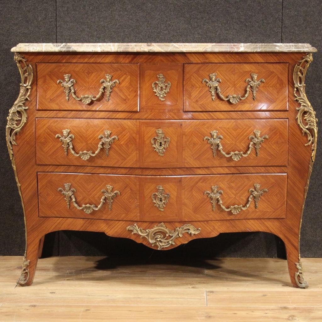 French dresser from the mid 20th century. Moved and rounded furniture in Louis XV style inlaid in rosewood with ornaments and handles in gilded and chiseled bronze. Chest of drawers equipped with two smaller parallel drawers placed under the top and