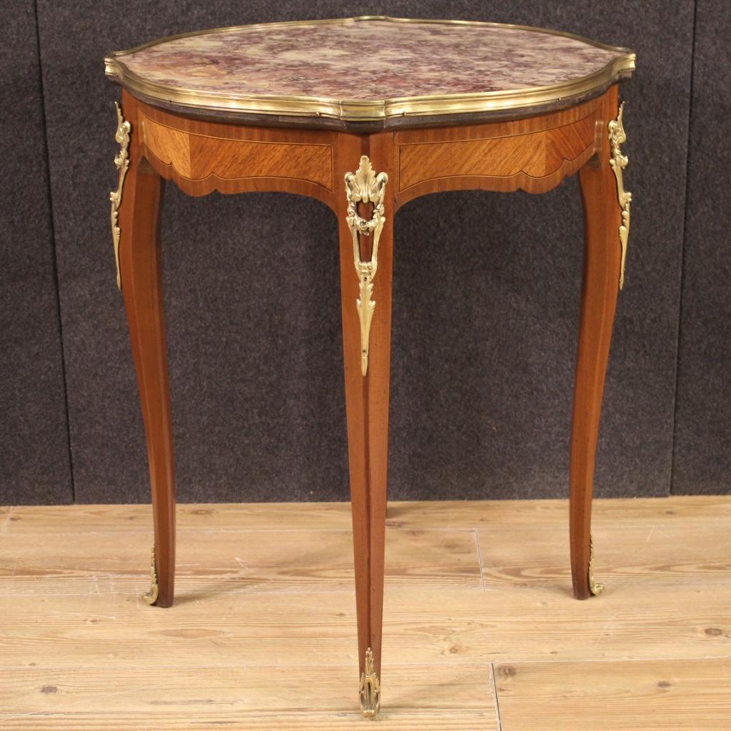 French side table from the 20th century. Furniture of beautiful line and pleasant decor inlaid and veneered in mahogany, maple, ebonized wood and fruitwood with decorations in gilded and chiseled bronze. Top in original marble adorned with lateral