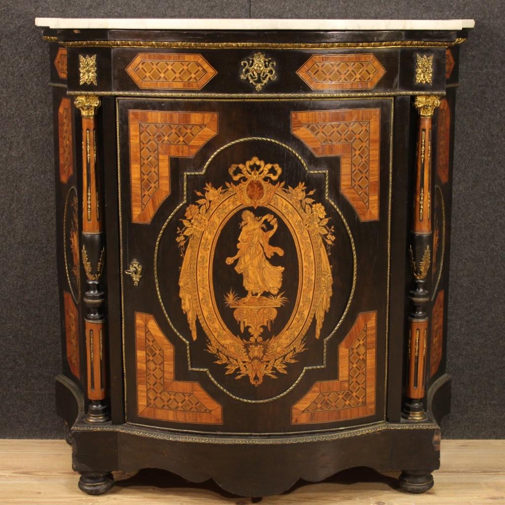 Italian sideboard from the early 20th century. Furniture of beautiful line richly inlaid in walnut, maple, burl, rosewood, ebonized wood and fruitwood with musical instruments on the sides and a female figure of neoclassical style on the door. Moved