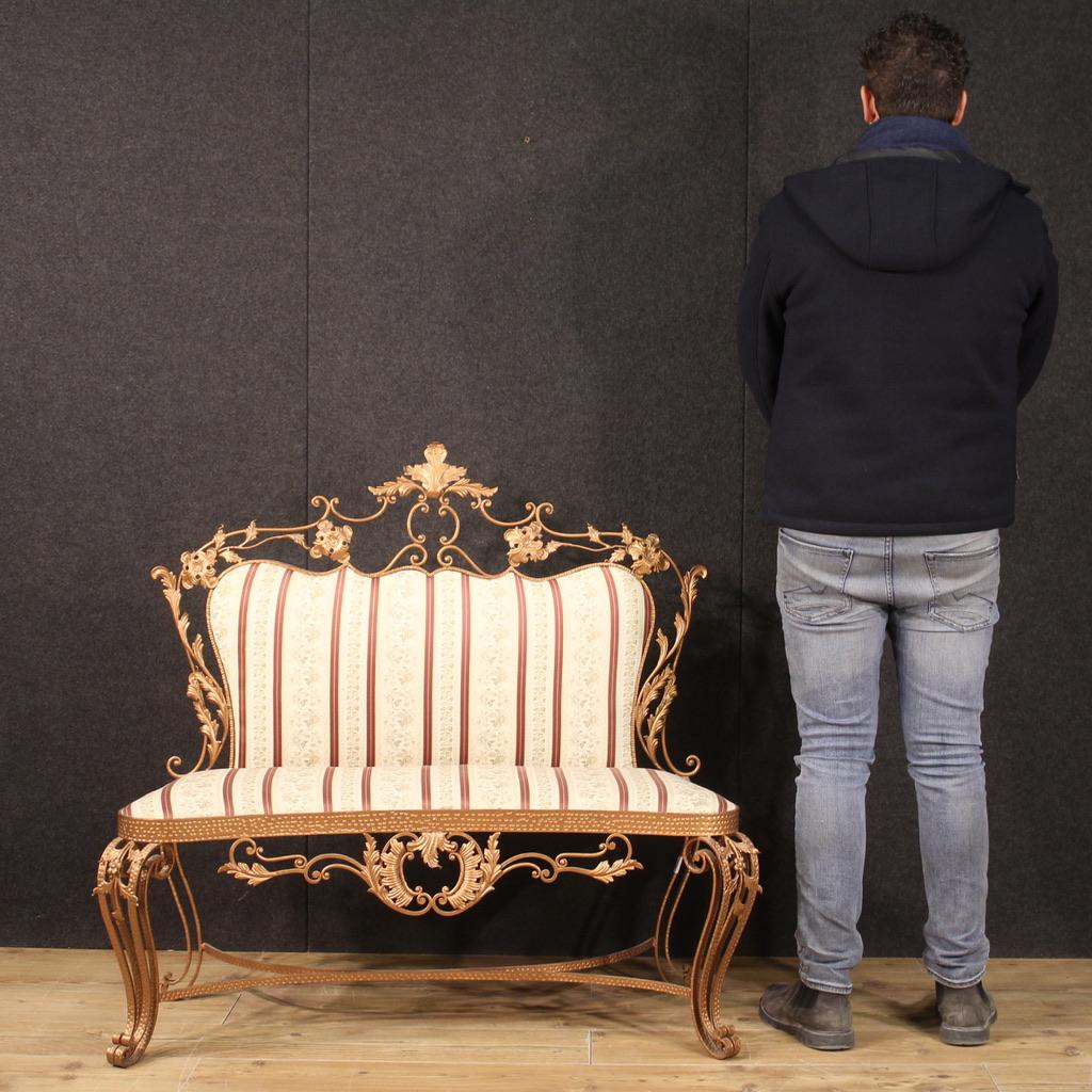 Italian sofa from the 60s. Furniture in gilded metal (bronze tint) and chiseled of Italian design in the Pier Luigi Colli style with very pleasant floral decorations. Sofa with seat and back upholstered in fabric with flowers in good condition. Seat