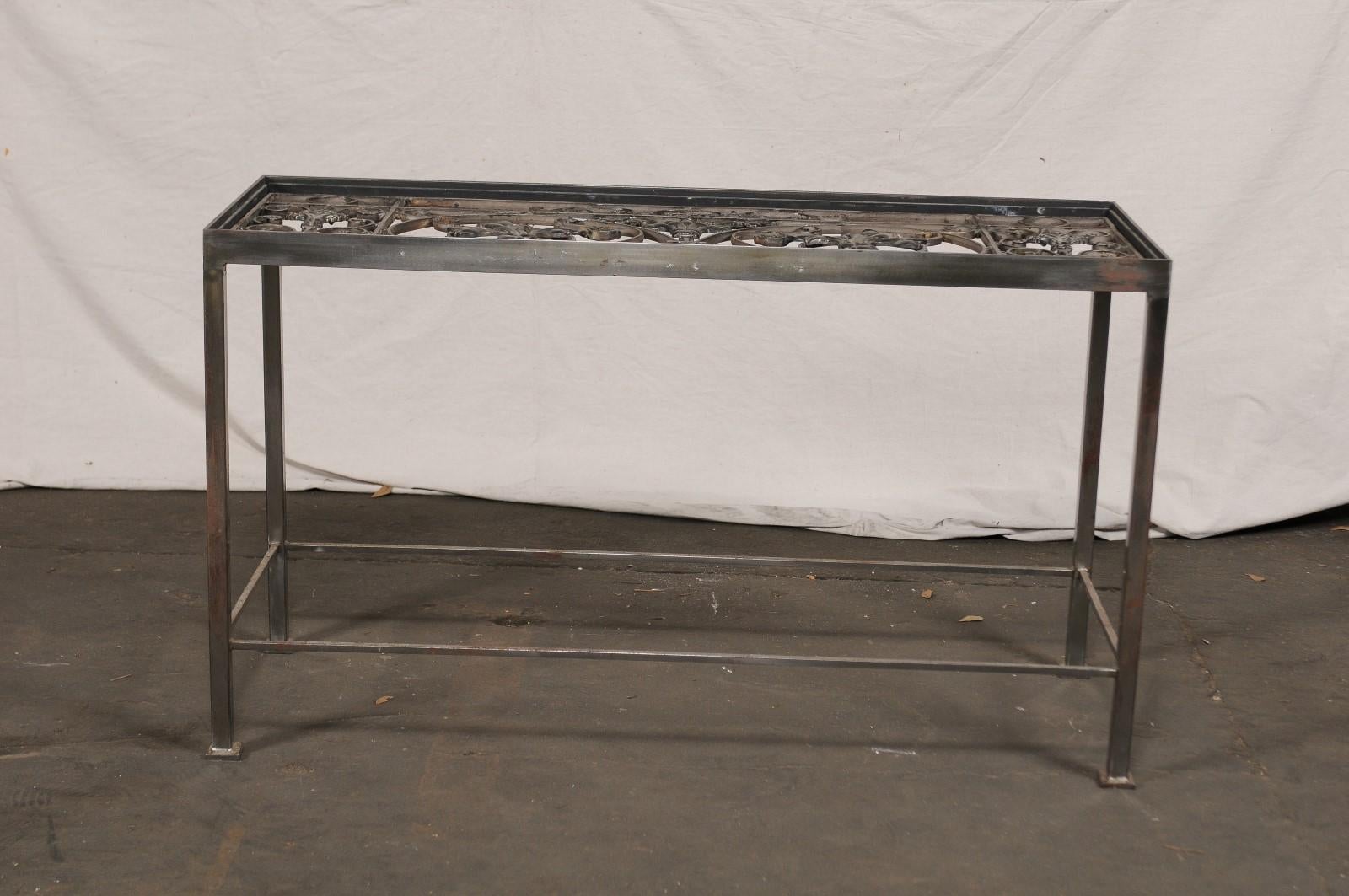 20th century iron console table with iron grate insert.