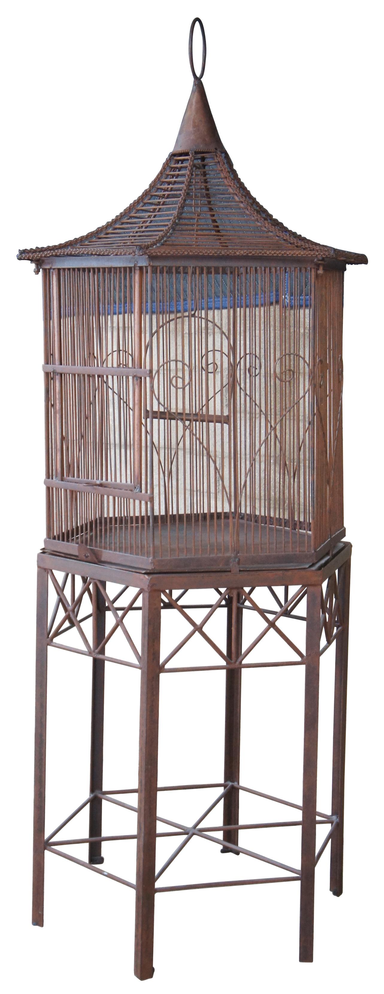 Vintage 20th century bird cage on stand. Made of iron with a pagoda style top and eight sided octogon house. Very nice action on the draw door.

Measures: 27