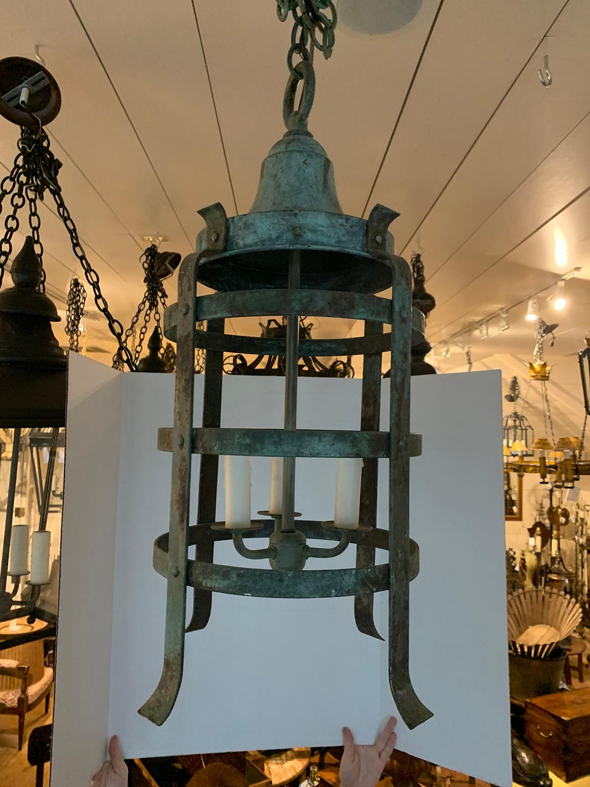 20th century iron three-light lantern with worn celadon finish
New wiring
No glass.