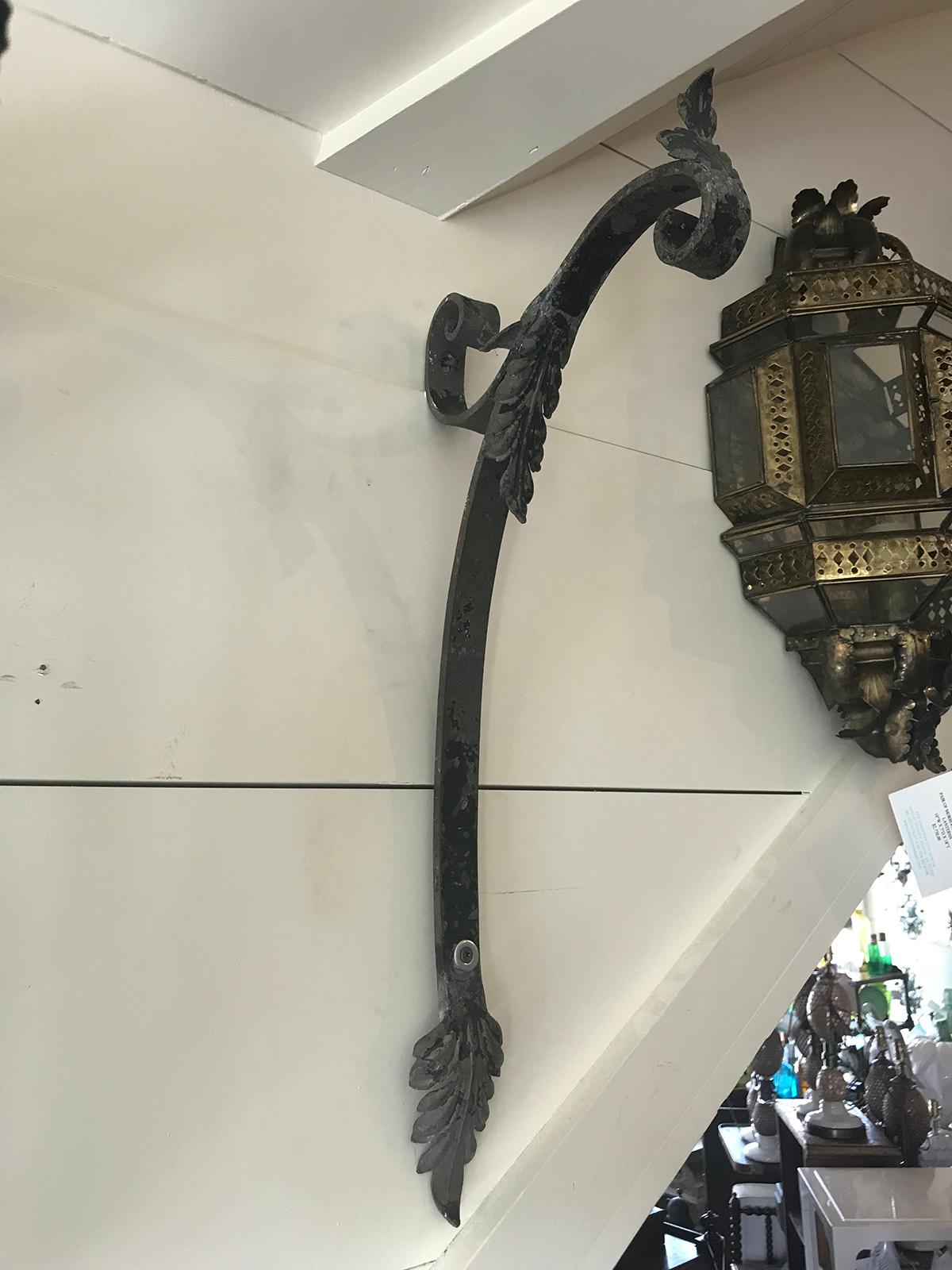 20th century iron wall bracket or arm with feather detail.