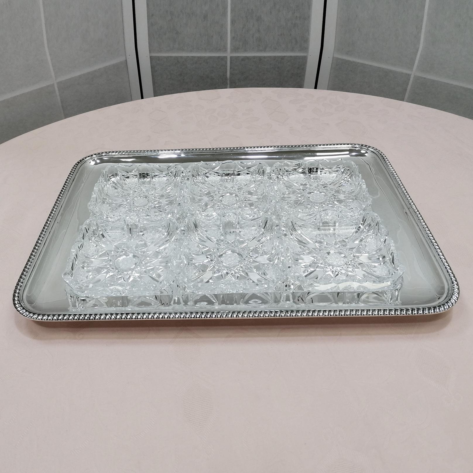 Rectangular tray in solid 800 silver with 6 removable crystals for different types of appetizers.
The tray is smooth with a welded edge with a rope design.
The original crystals of the time are hand-cut and fit perfectly into the hollow of the