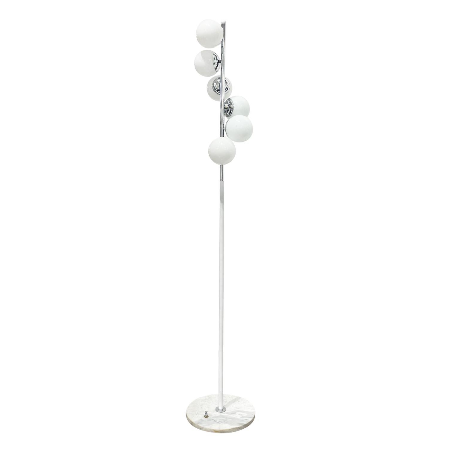 A vintage Mid-Century Modern Italian Alberello floor lamp made of hand crafted chrome, designed and produced by Stilnovo, in good condition. The floor lamp is composed with six round frosted opaline glass shades, halted by a short perforate chrome