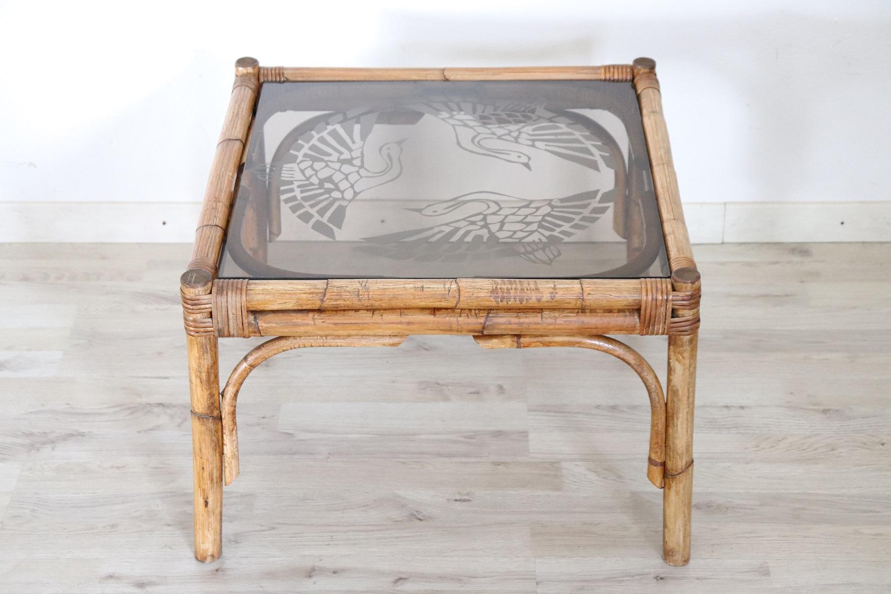 Rare Italian Art Deco sofa table in bamboo. The table was made by Italian artisans around in 1930s. Completely made with bamboo and a finely decorated glass top with refined quality. This furniture is perfect for your patio or your garden in summer.