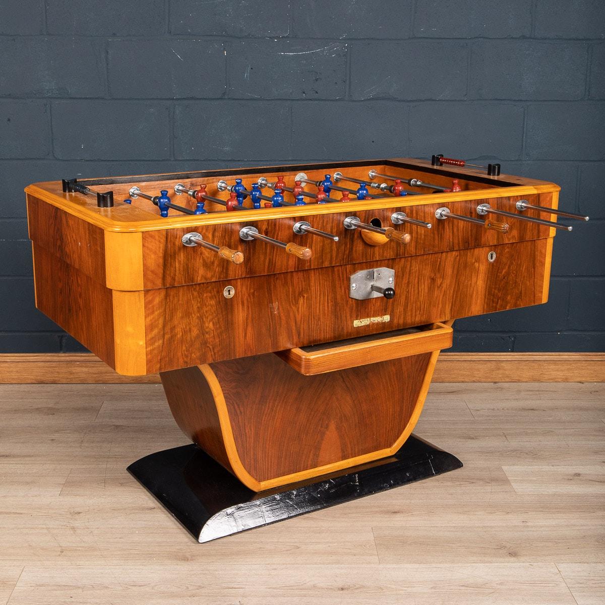 A truly striking table football table made in Italy around the middle of the 20th century. The strong Art Deco structure has a wonderful two-tone wood veneer, a glass playing surface and retaining some superb original features like the coin operated