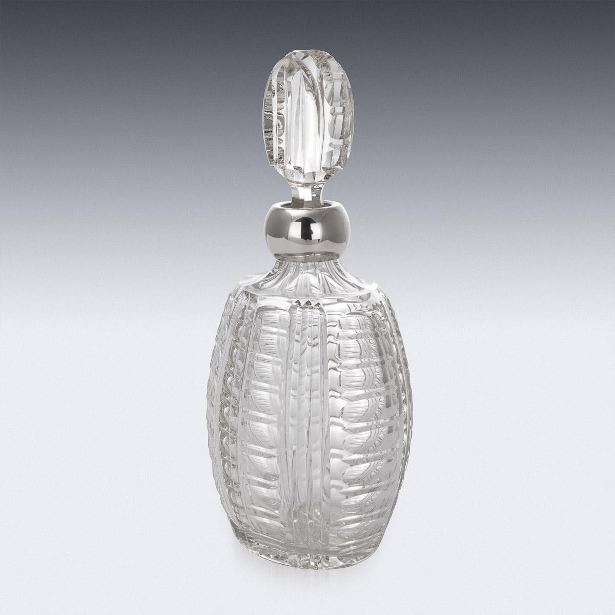 Stylish mid-20th century Italian Art Deco style solid silver and glass decanter. Of mid-size with cut crystal glass body and mounted with elegant oval stopper. Applied with a pronounced silver collar. This decanter can hold up to 0.5 liter of your