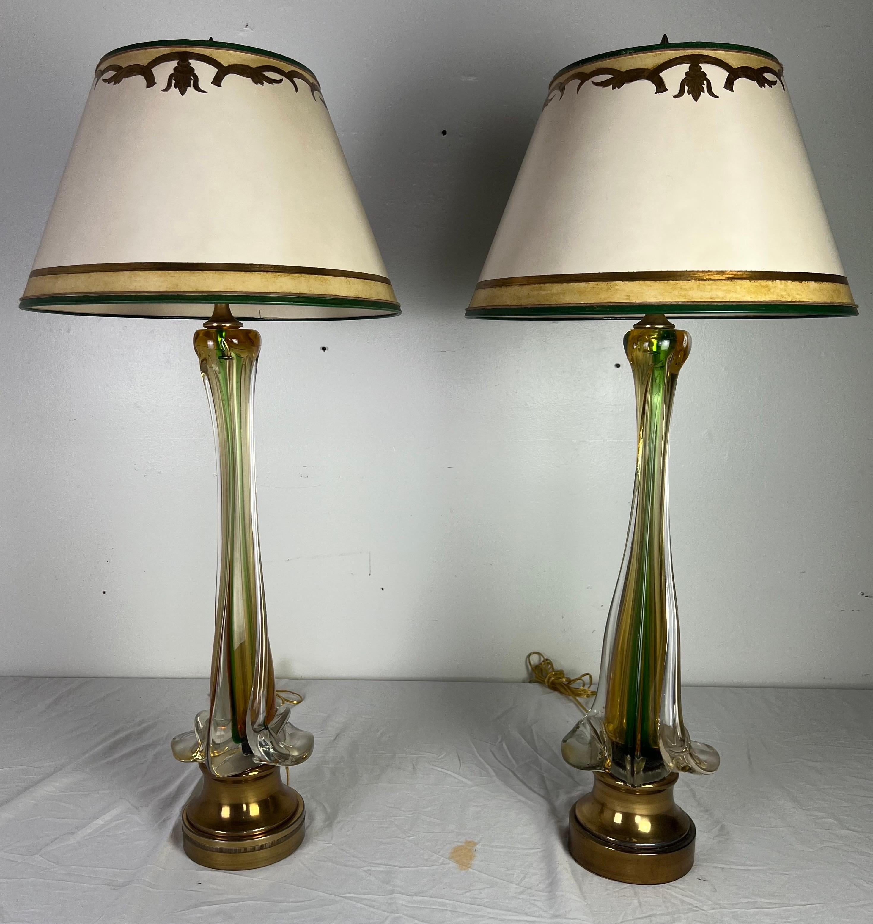 Pair of 20th century Italian Art Glass lamps with custom hand painted parchment shades.  The tall slender lamps have shades of green and gold and stand on brass bases.  