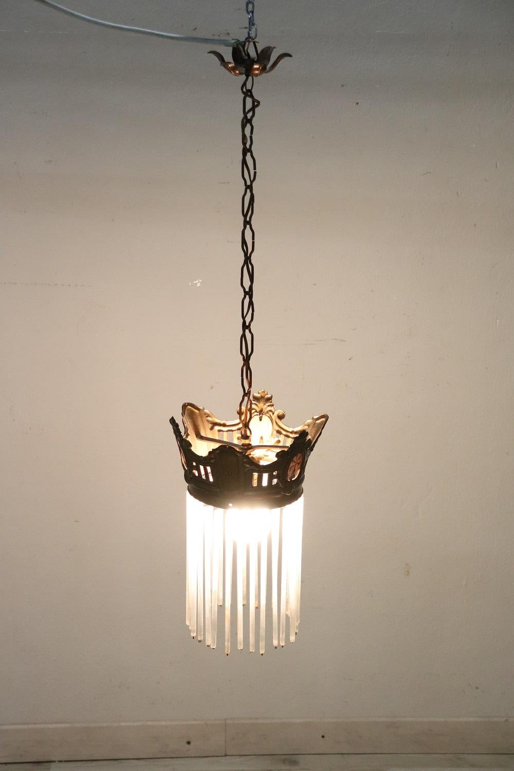 Splendid Italian Art Nouveau chandelier in gilded bronze 1-light, 1910s. Beautiful decorated with glass pendants. The bronze is finely chiseled. Perfect condition ready to light up your beautiful home.