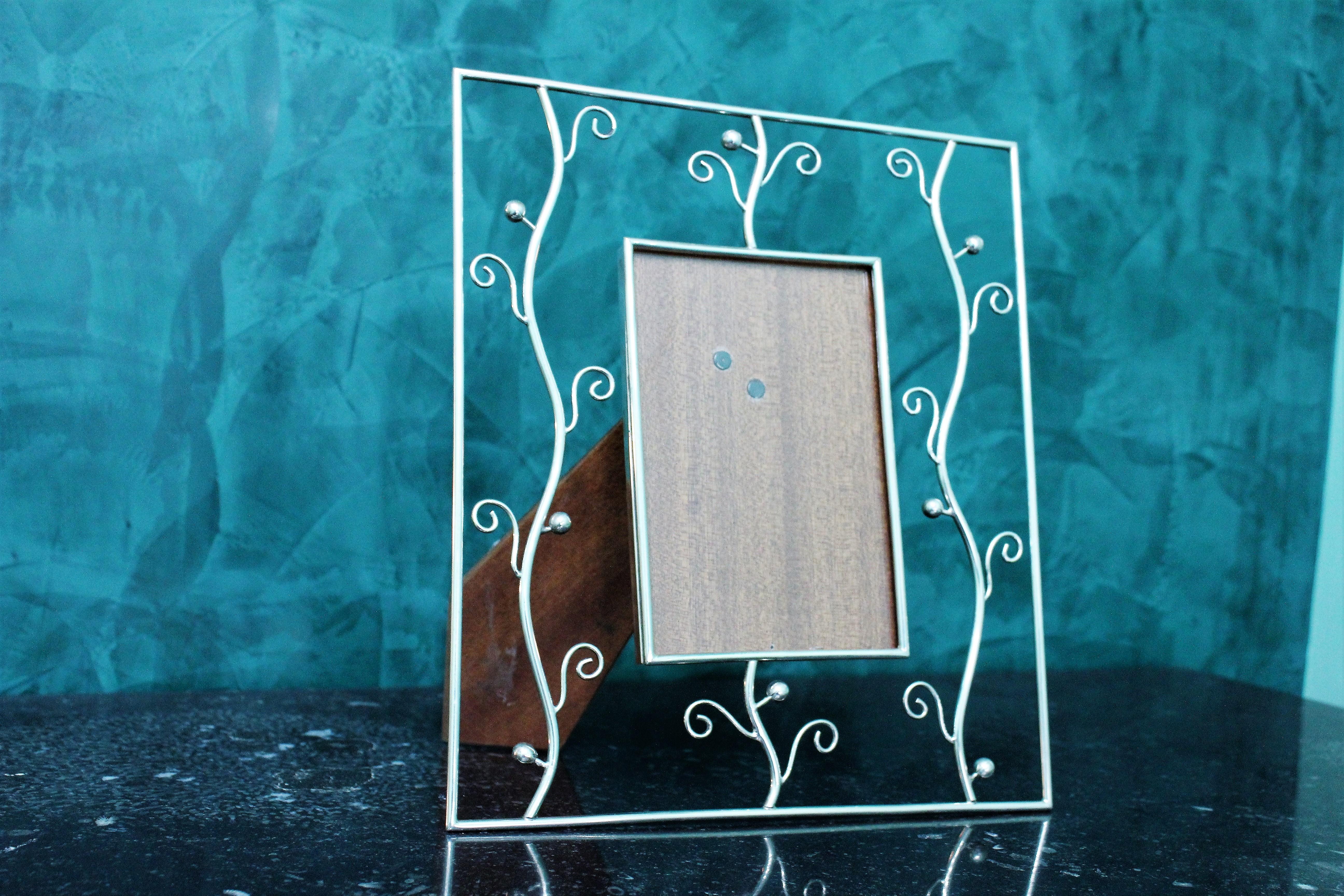 Artistic sterling silver picture frame realized in Florence, circa 1970s.
Wooden back in very good condition.
Dimensions: 26.5 x 23 cm - picture size 10 x 15 cm Weight 525 gr.
Realized by Silversmith Politi Mario from Florence, circa 1970s.