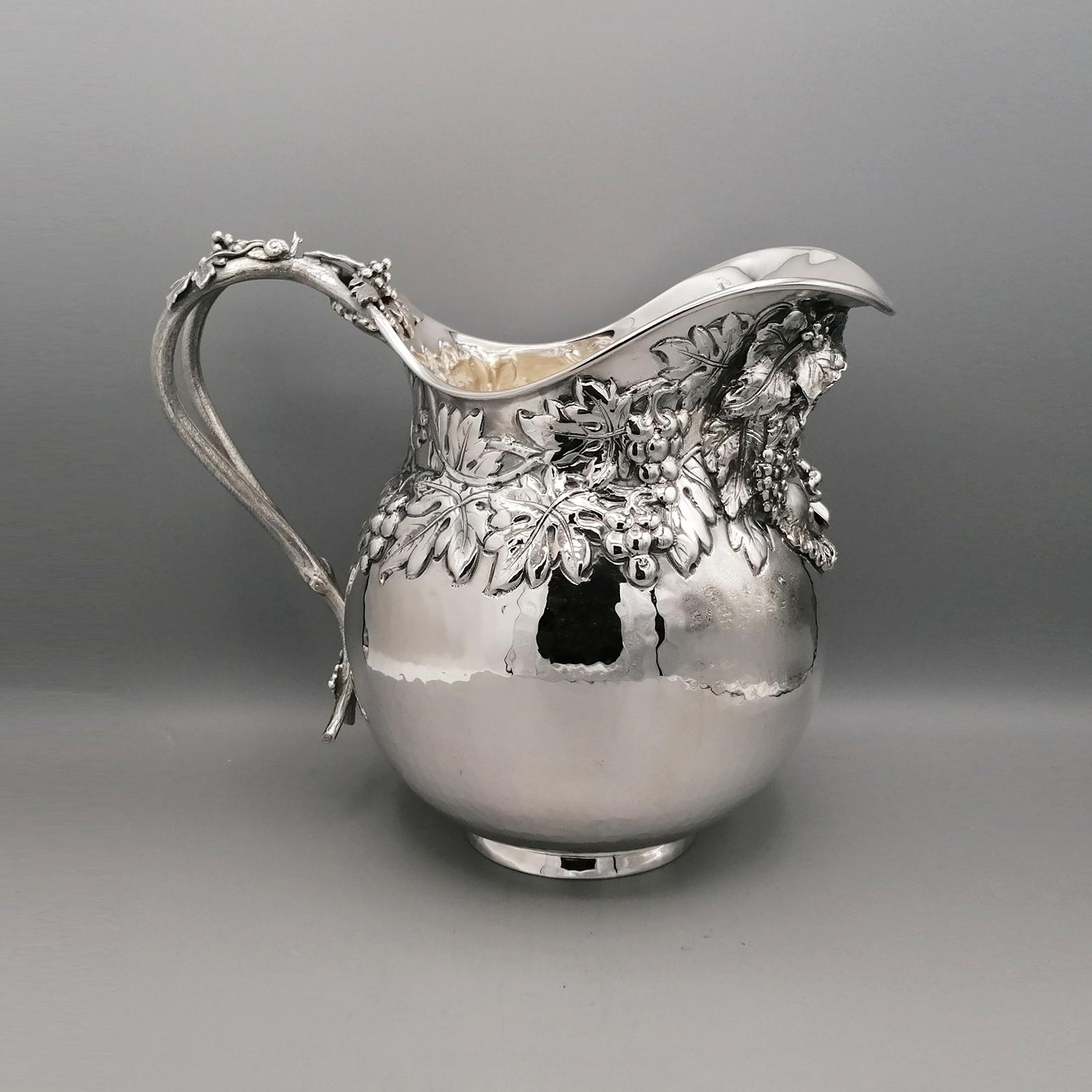 Gorgeus solid silver 800 jug.
The body, an hammered ball shape, is embossed in the upper part with grapes and vine leaves.
The Bacco mask is embossed in the front.
The handle of the jug is melted and reproduces leaves with leaves and acines.
Made by