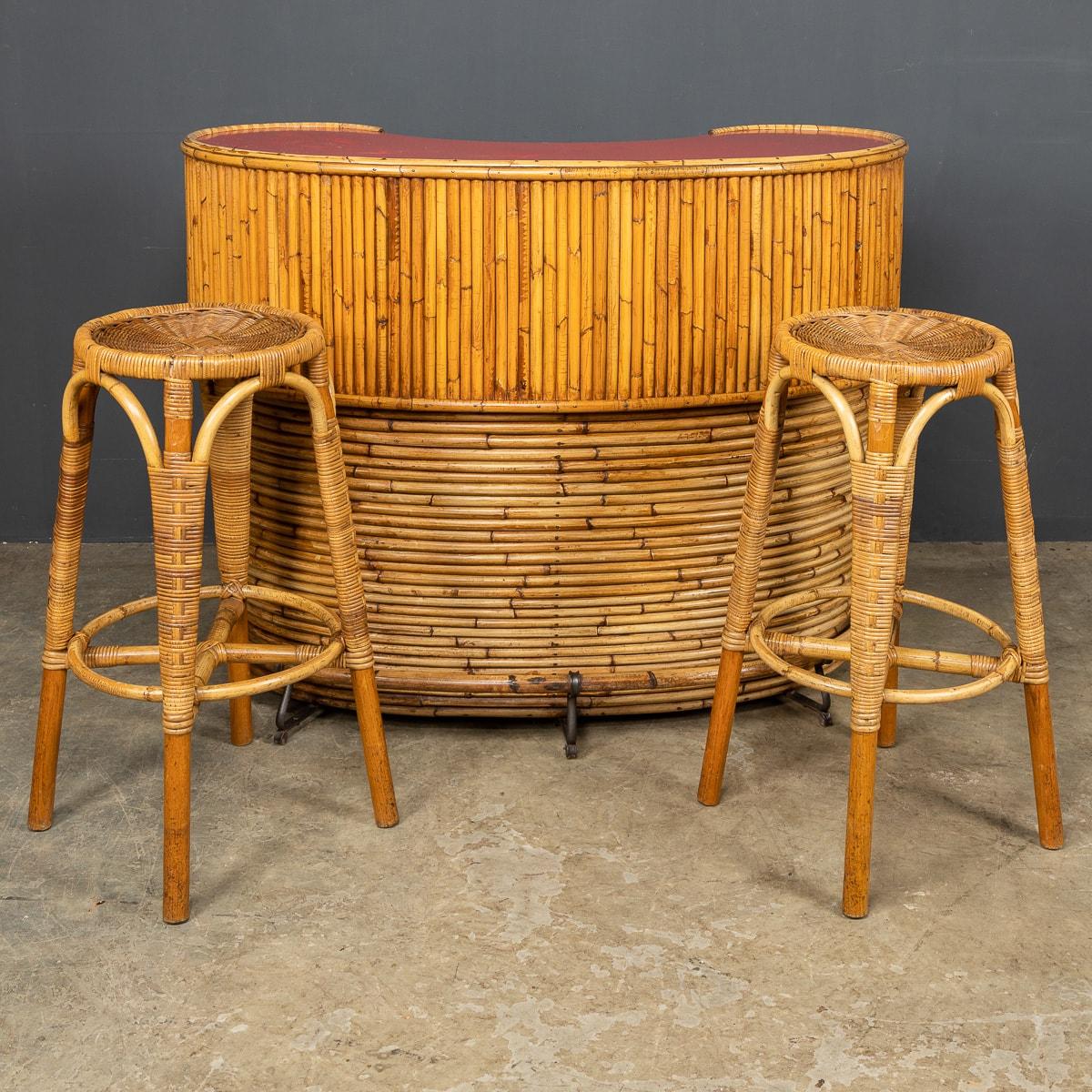 Iconic mid-20th century Italian bar in bamboo with original red bar top and one shelf inside with a pair of bamboo framed rattan stools, made in the late 1950s, when the “Tiki Bar” was all the rage.

CONDITION
In Great Condition - No
