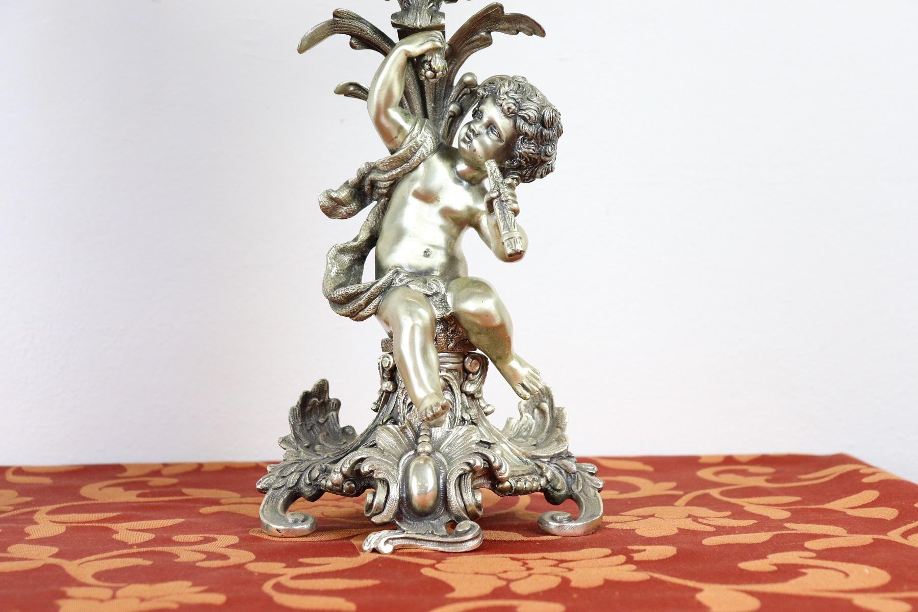 Pair of important silver candelabras five flames silver 800 important working with cherubs. Baroque Style Italian production 1970s about silversmith Milan.  Trademark of the Italian manufacturer 862 MI Fernando Cattaneo Milan. Weight kg 10,876.