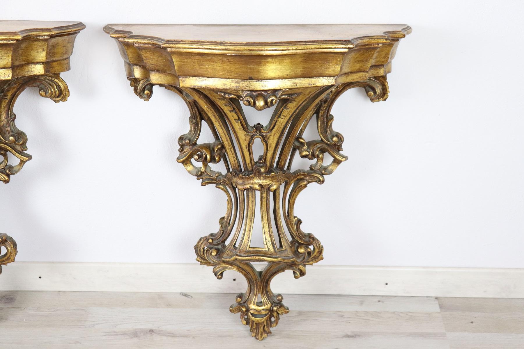 Italian Baroque style pair of nightstands. Rich carved and gilded wood they must be fixed to the wall. Great woodwork with lots of curls and swirls of typical Italian Baroque taste. The nightstands have a convenient drawer. On request we also have