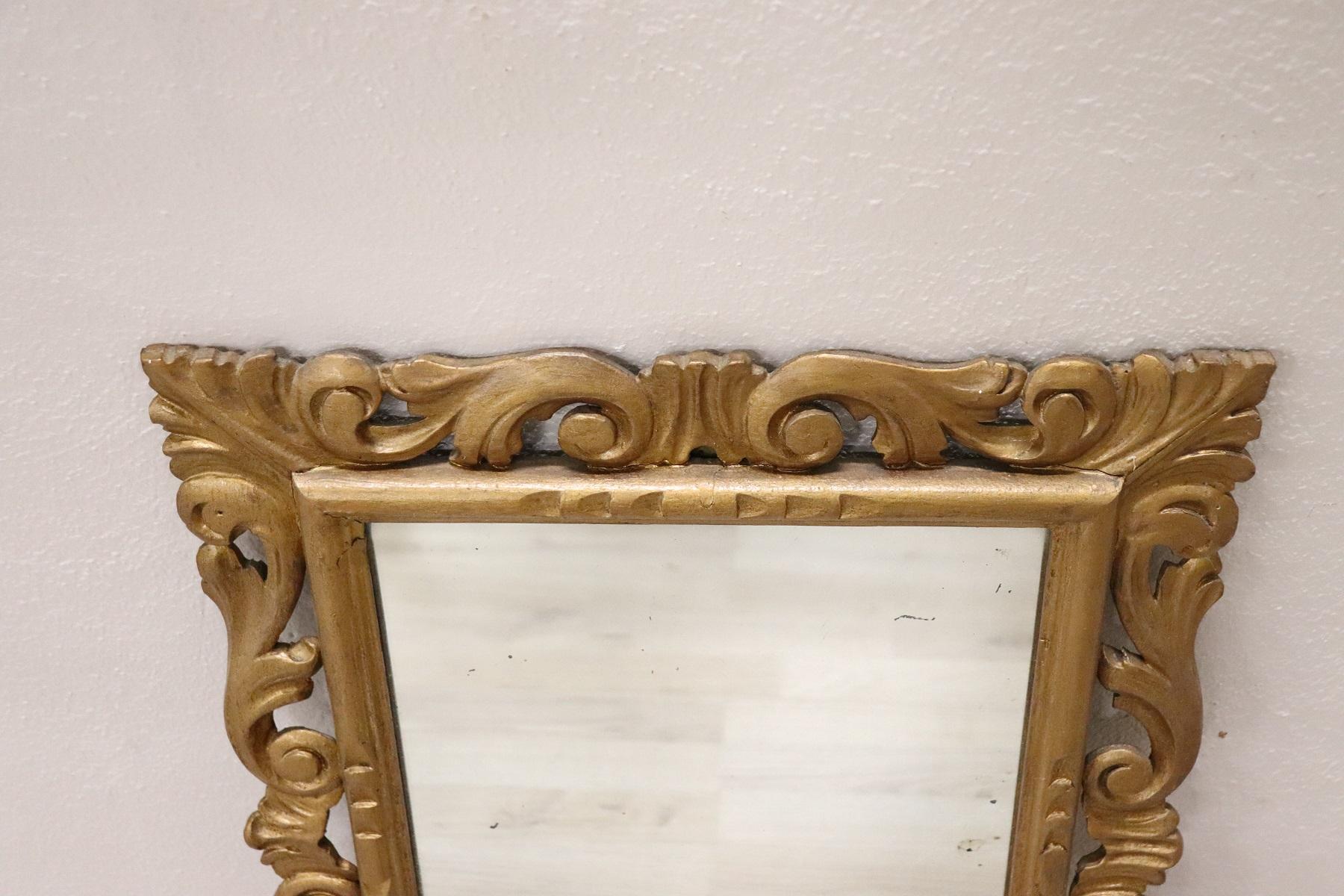 Refined Italian Baroque style small mirror with frame in carved and gilded wood 1950s. Conditions good.