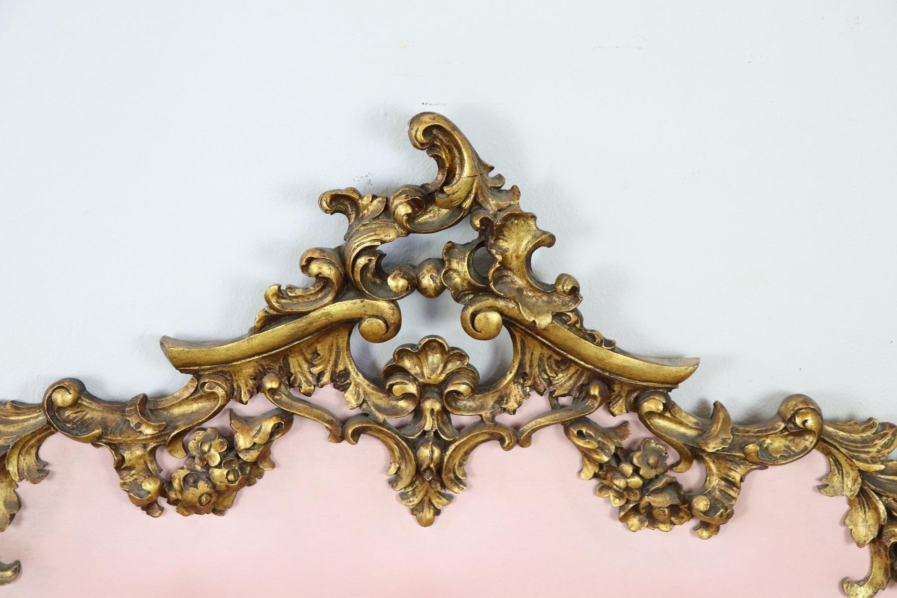 Italian Baroque style bed frame. Rich double bed headboard in carved and gilded wood. Great woodwork with lots of curls and swirls of typical Italian Baroque taste. In the central part a refined pink fabric with capitonné workmanship. On request we