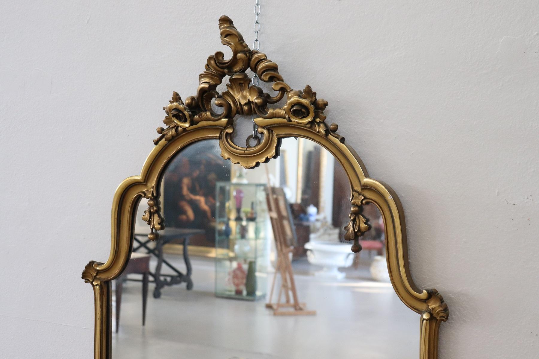 Beautiful elegant large mirror in perfect Baroque style wood finely and richly carved with swirls of great refinement decorated in gold.