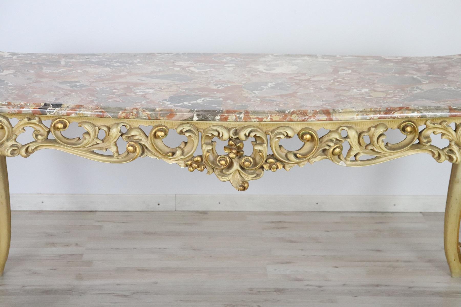 Italian Baroque style large dining room table. Rich table in carved and gilded wood. Great woodwork with lots of curls and swirls of typical Italian Baroque taste. large beautiful marble-top. Table ideal into a living room or office. In good