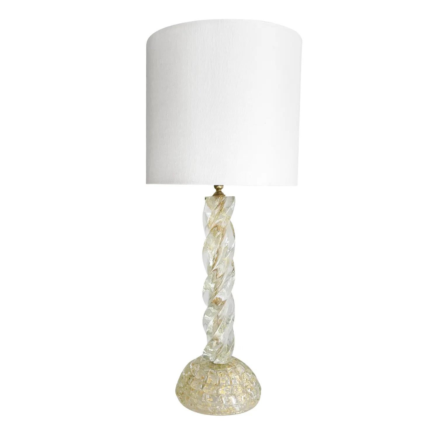 A clear, vintage Mid-Century Modern Italian table lamp with a new white shade, made of hand blow Murano glass, designed by Ercole Barovier and produced by Barovier & Toso, in good condition. The tall desk light was selected by Samuel Marx for the