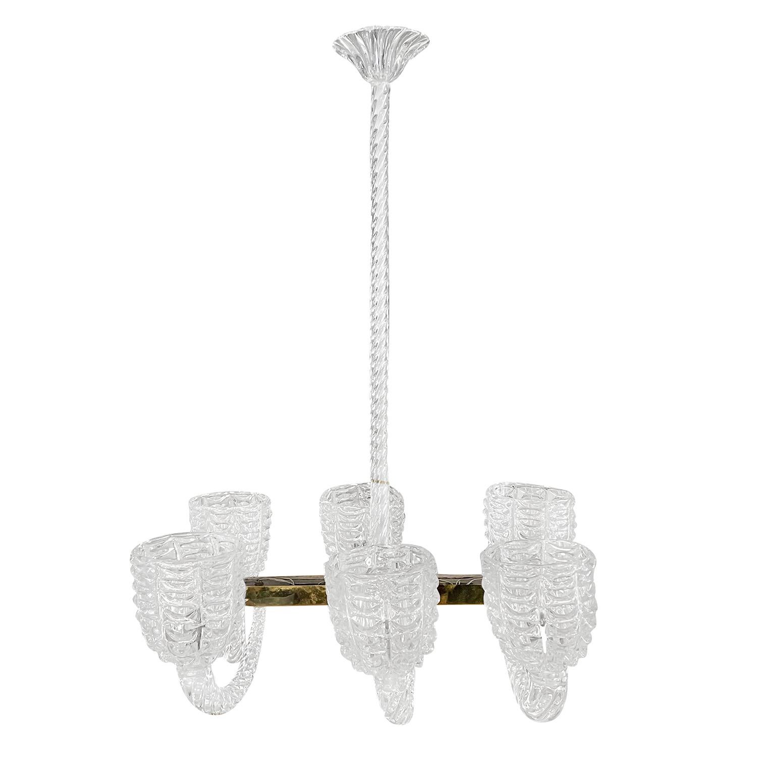 A vintage Mid-Century Modern Italian chandelier made of a rectangular brass base and hand blown Murano glass, designed by Ercole Barovier and produced by Barovier & Toso, in good condition. The pendant, ceiling light is composed with six round