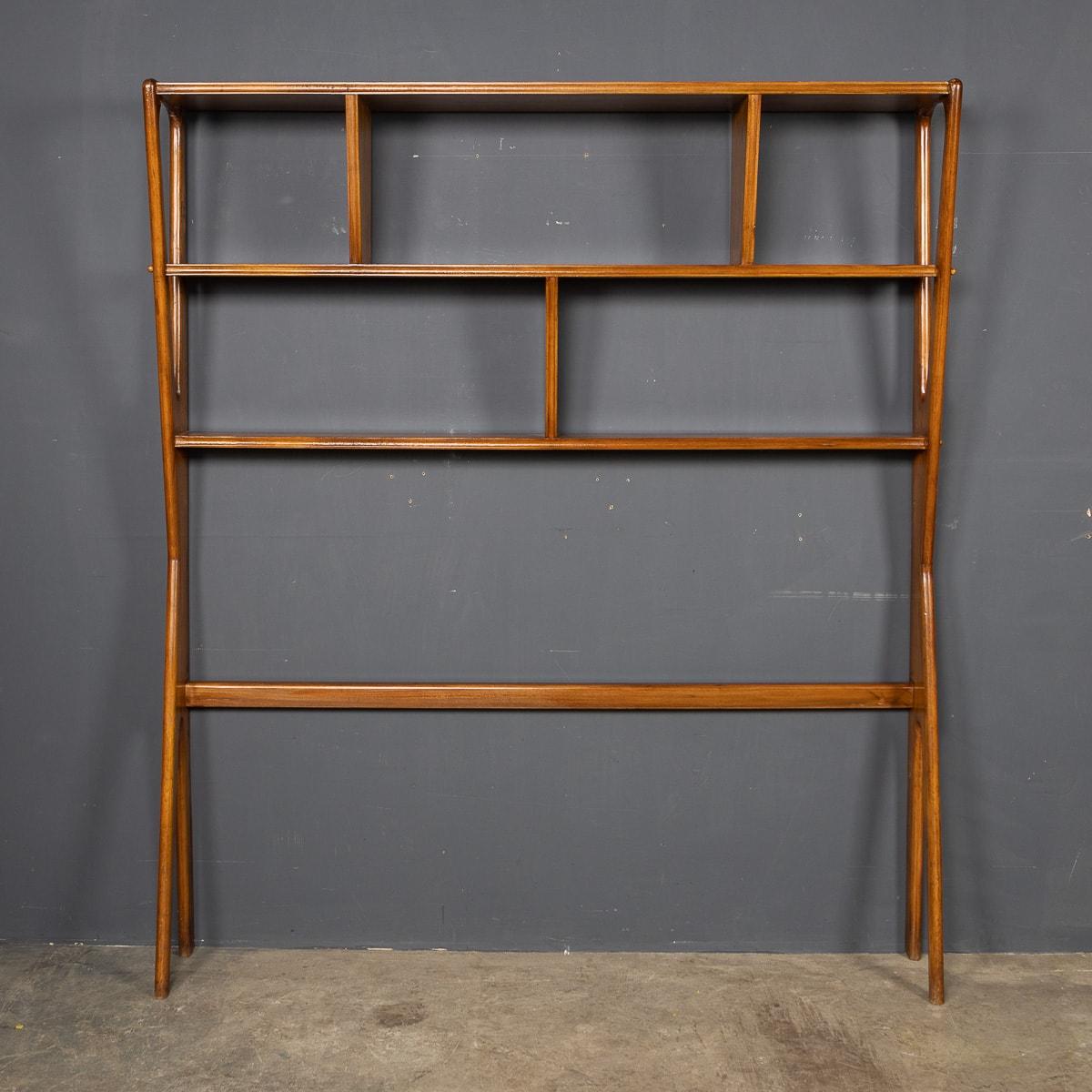 A mid-20thC Italian bookcase in a beautifully curved beechwood frame. This piece can also be used as a room divider. A very stylish and versatile piece of modernist design.

CONDITION
In Great Condition - No Damage.

SIZE
Height: 179cm
Width: