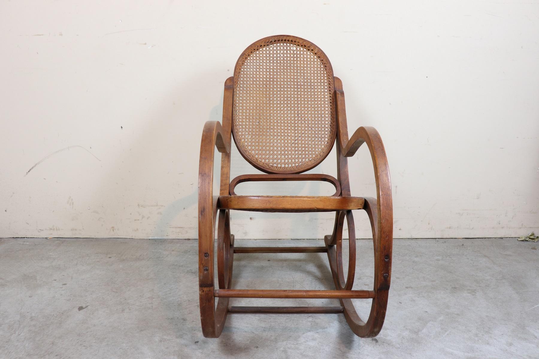 Beautiful and particular rocking chair made of bent beech wood in Thonet style. Italian production 1930s circa. Perfect condition of both wood and cane. The barrel is woven by hand passing every single thread.