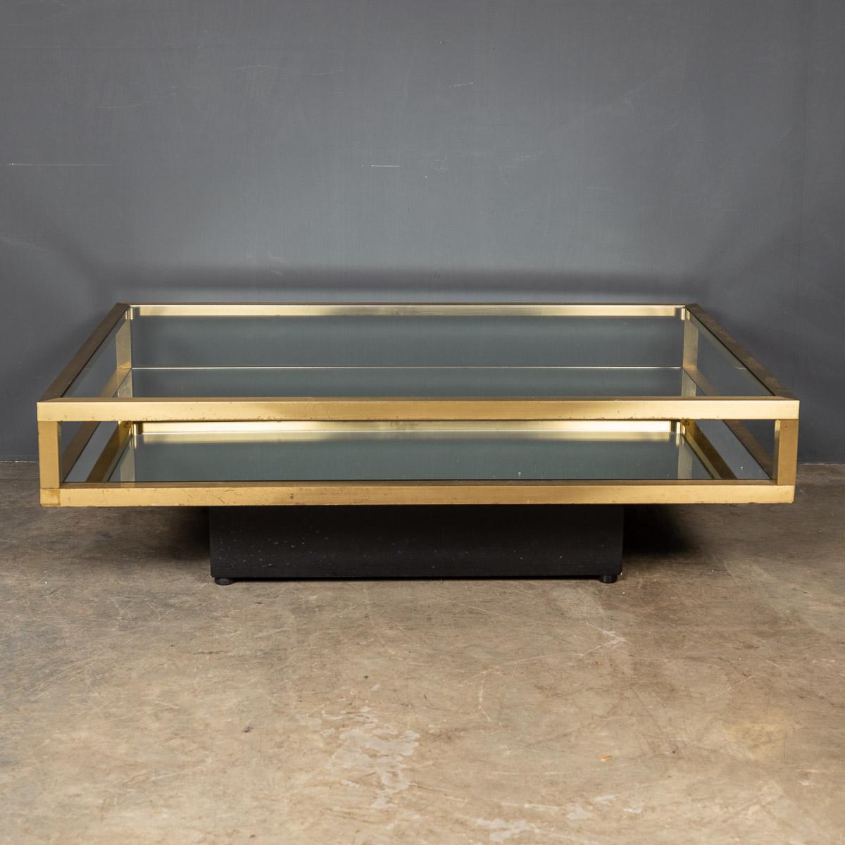 Striking 20th century Italian brass coffee table. This 1970’s vitrine table has a mirrored lower shelf and a clear glass surface with a black plinth.

Condition
In great condition - wear consistent with age.

Size
Width: 80cm
Depth: