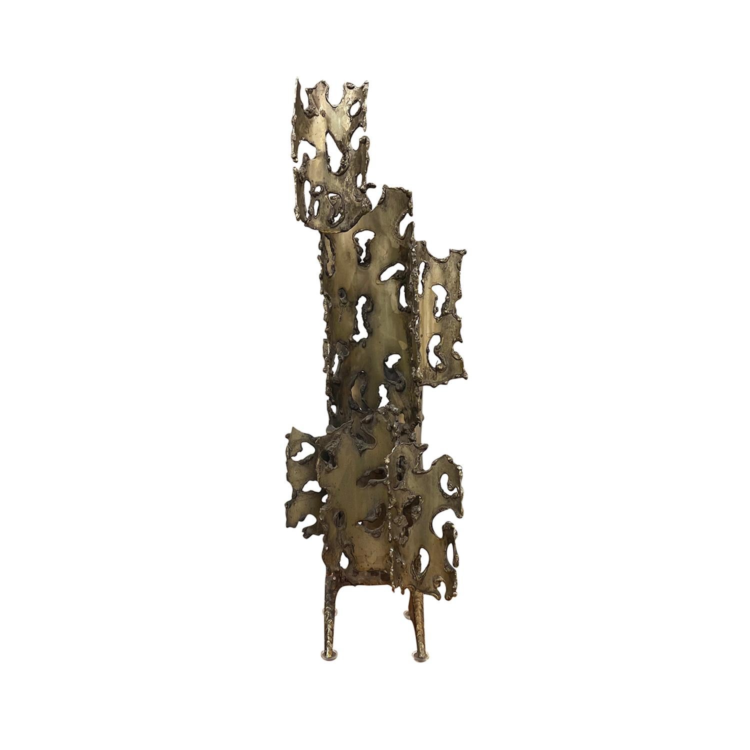 An abstract, vintage Mid-Century modern sculpture made of hand crafted cut steel, in good condition. The detailed Brutalist décor piece is enhanced by many different metal pieces, supported by a triangular base. Wear consistent with age and use.