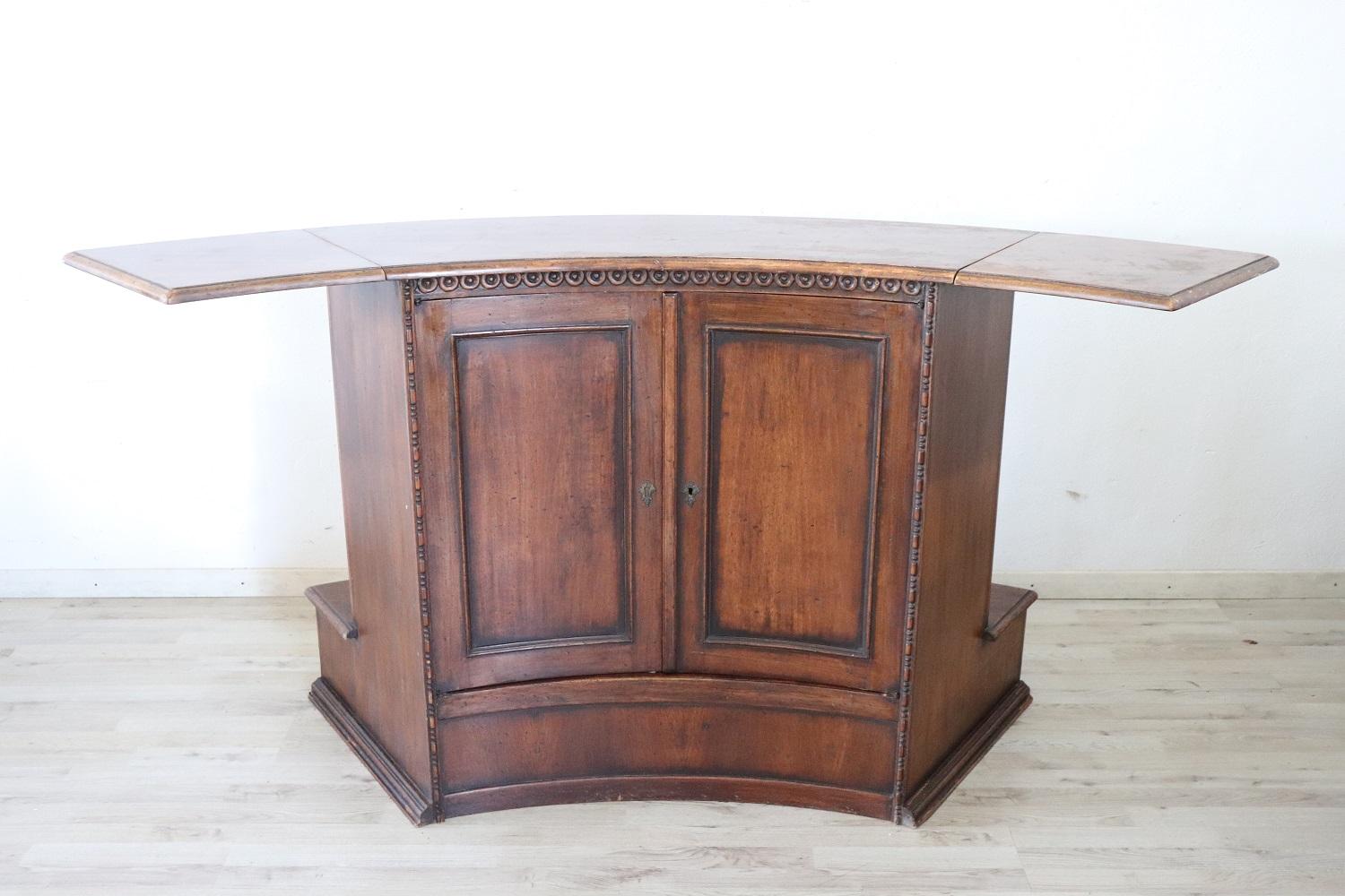 Beautiful and rare Italian bar counter 1980s. Made of solid walnut. Equipped on the sides with two additional support surfaces. The service side has a compartment for storing bottles and glasses. Used good conditions.