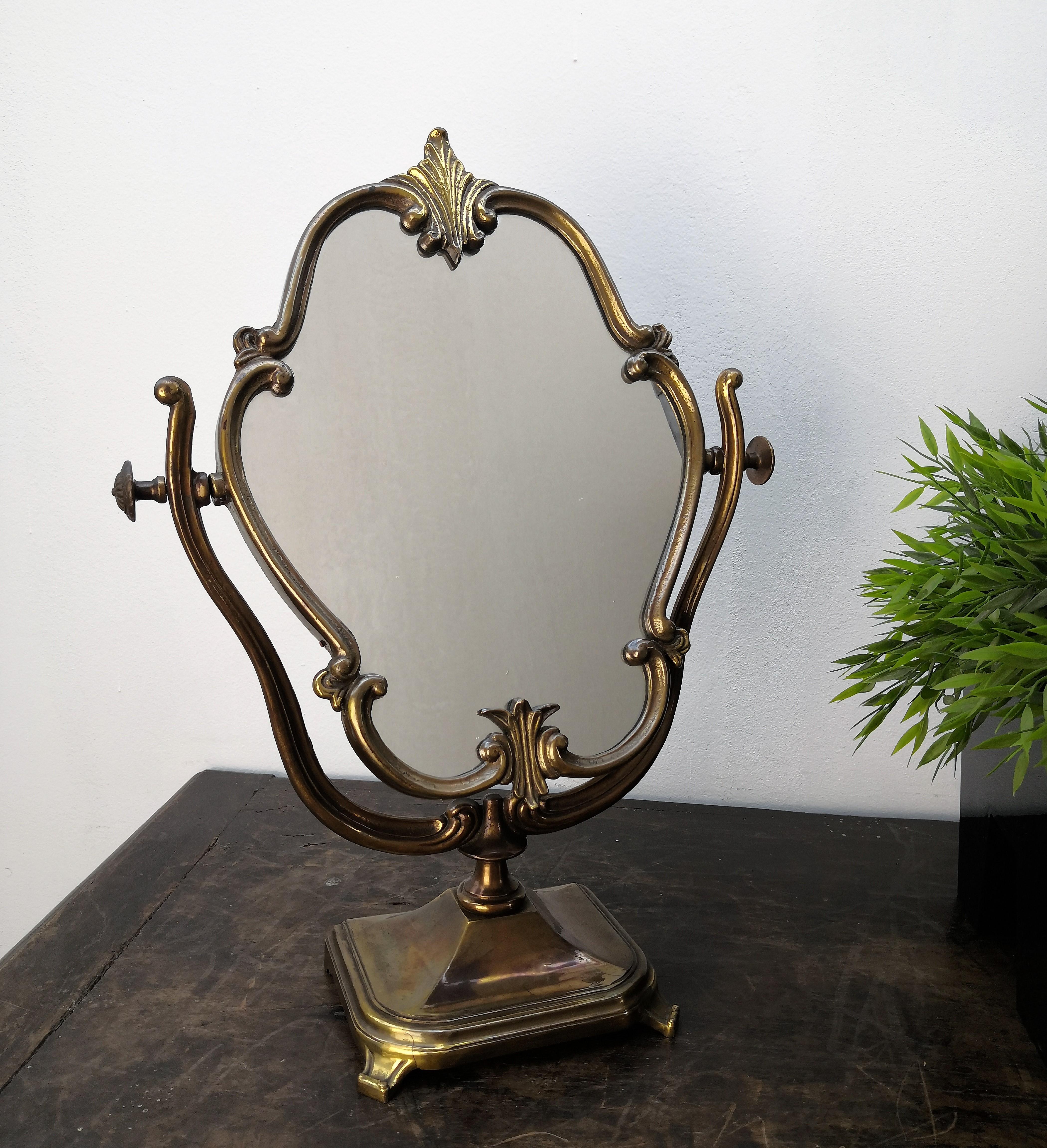 Beautiful Italian antique gilt bronze 20th century miniature vanity tabletop cheval mirror. Set on a square base from which two curved legs hold the mirror with adjustment screws to the top and with decorated bases of leaf and dart decoration. The
