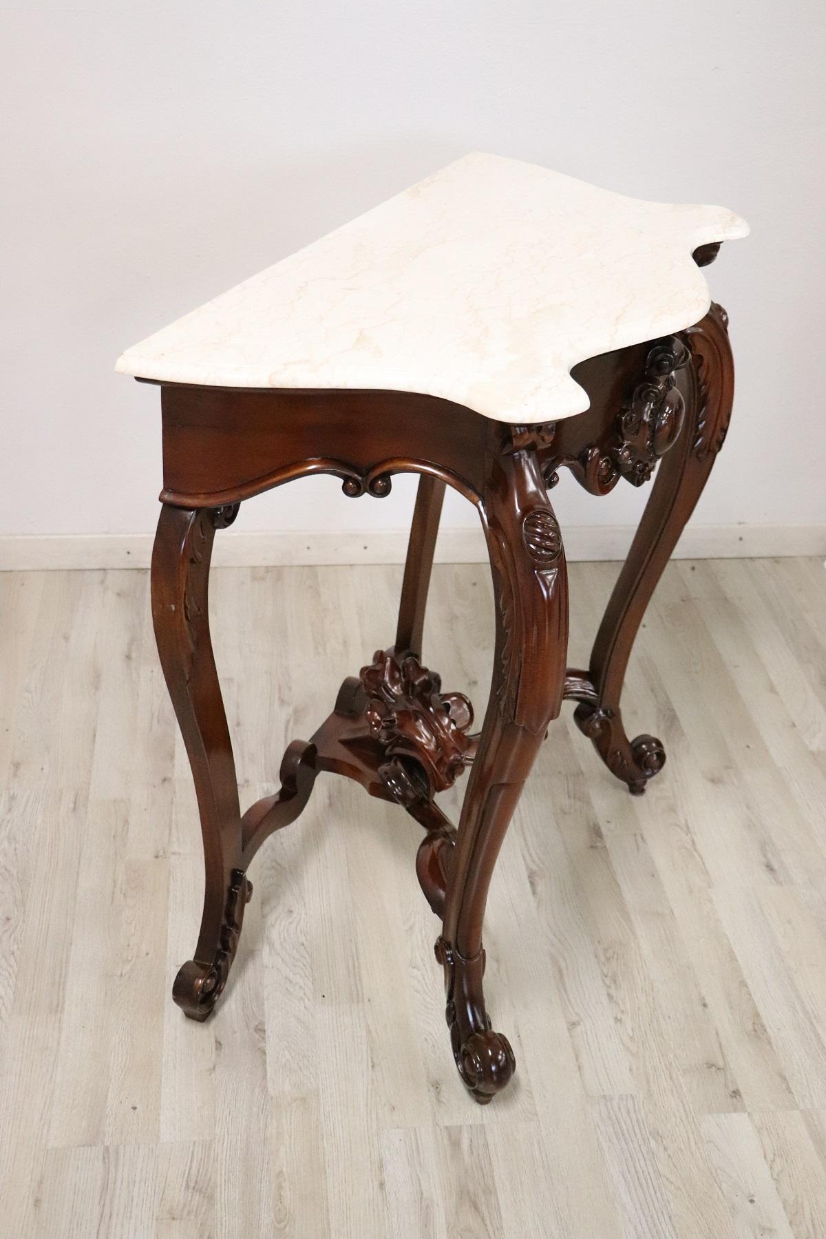 Console table of rare small size mid-20th century in Louis Philippe style. The console is made of solid carved walnut with floral decorations. Elegant Italian marble top. Rare due to its small size, perfect to be placed even in small rooms or