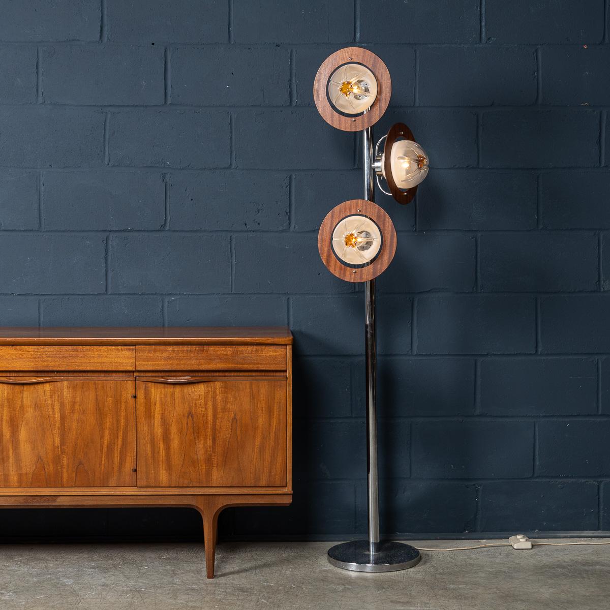 A striking chrome and glass floor lamp designed by Mazzega in Venice, Italy, circa 1970. This sculptural piece features three hand-blown glass diffusers that graduate from opalescent white to clear with a subtle touch of orange, creating a soft and